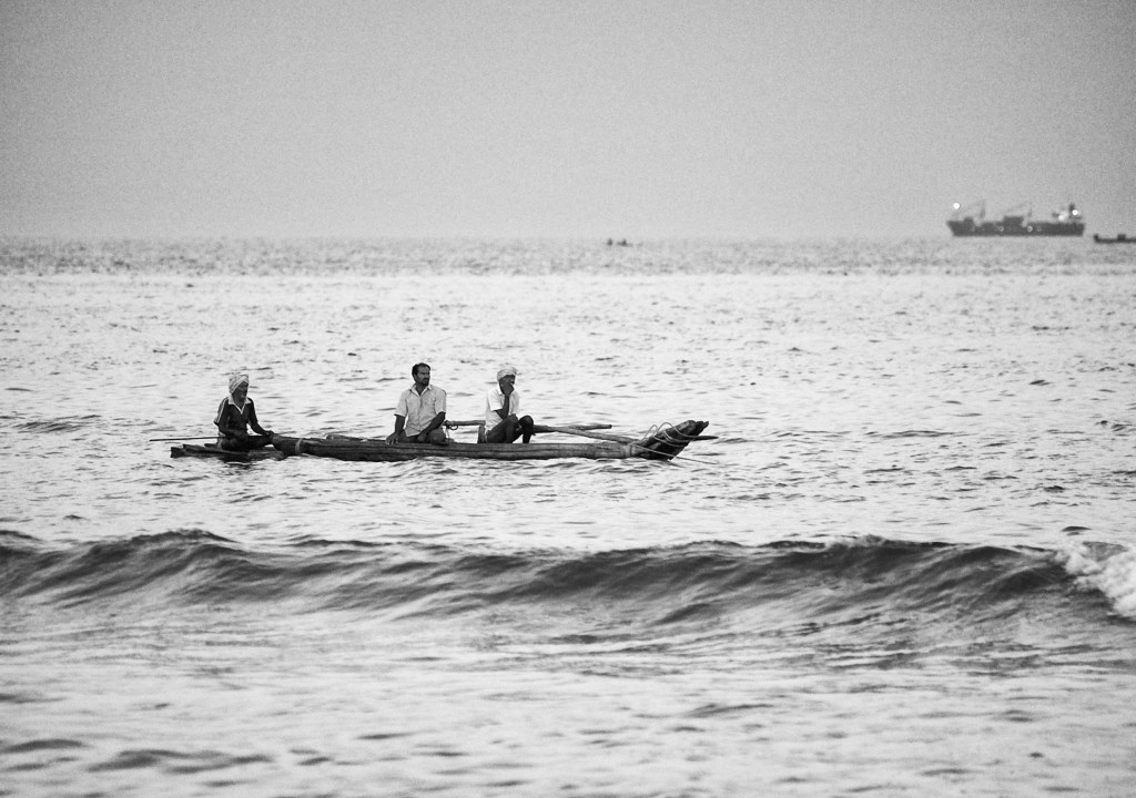 Fishermen on a wooden catamaran ride, Marina Beach, Bay of Bengal, Chennai, India