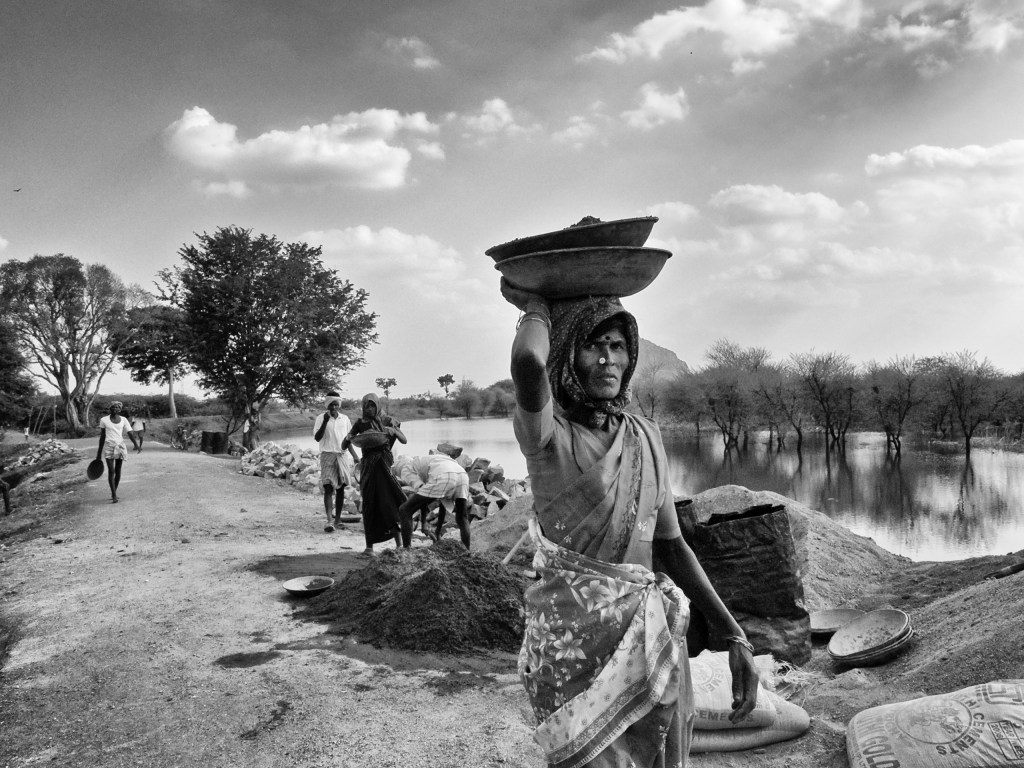 A woman construction worker at the road works, T.Kallupatti, Tamil Nadu, India.