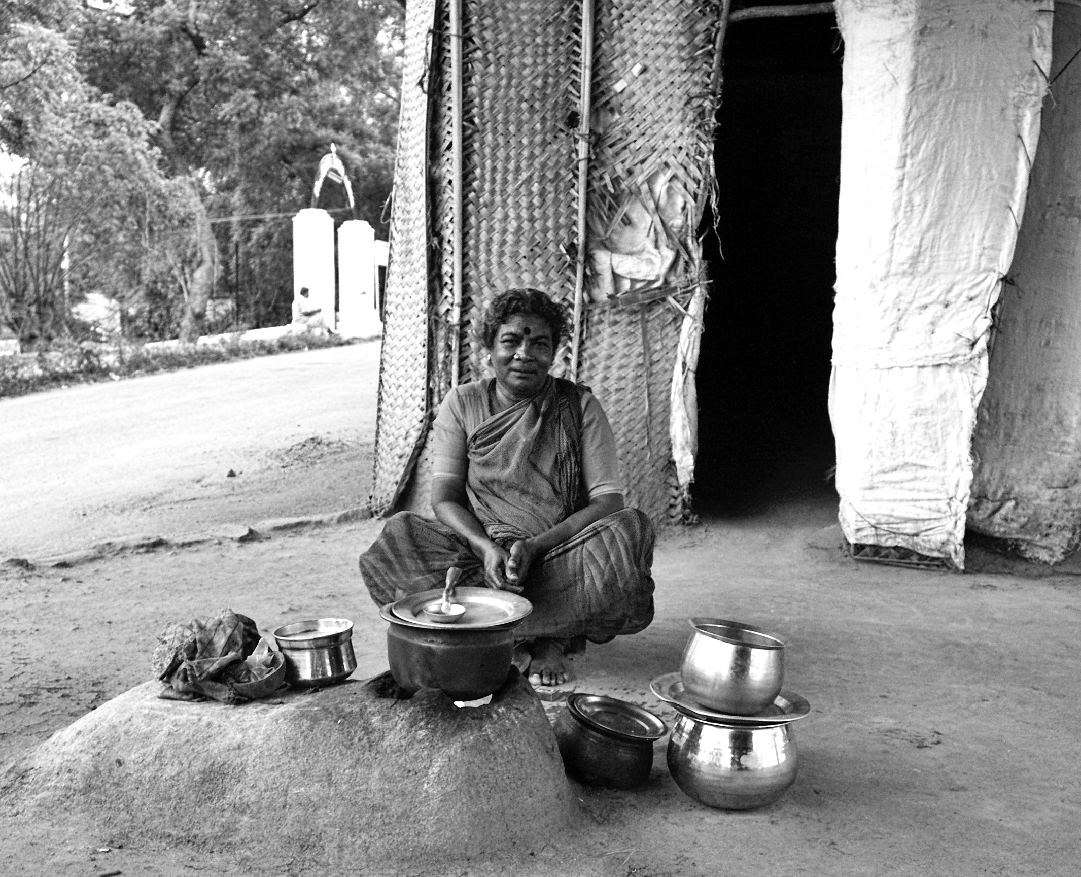 She had setup a small home under the flyover bridge with few thatches and cloths and preparing her evening meal. She got initially afraid thinking I was some enforcement officer. She was happy after I pacified her.
