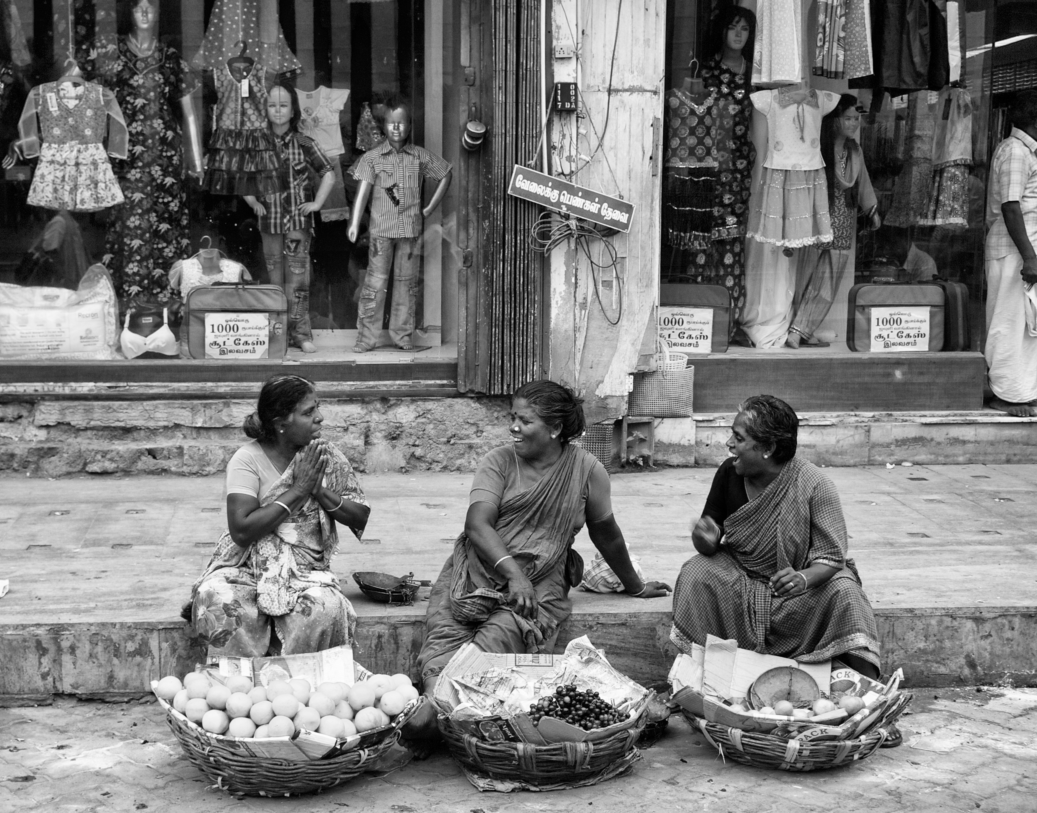 Street vendors, having an animated chat. Madurai, Tamil Nadu, India