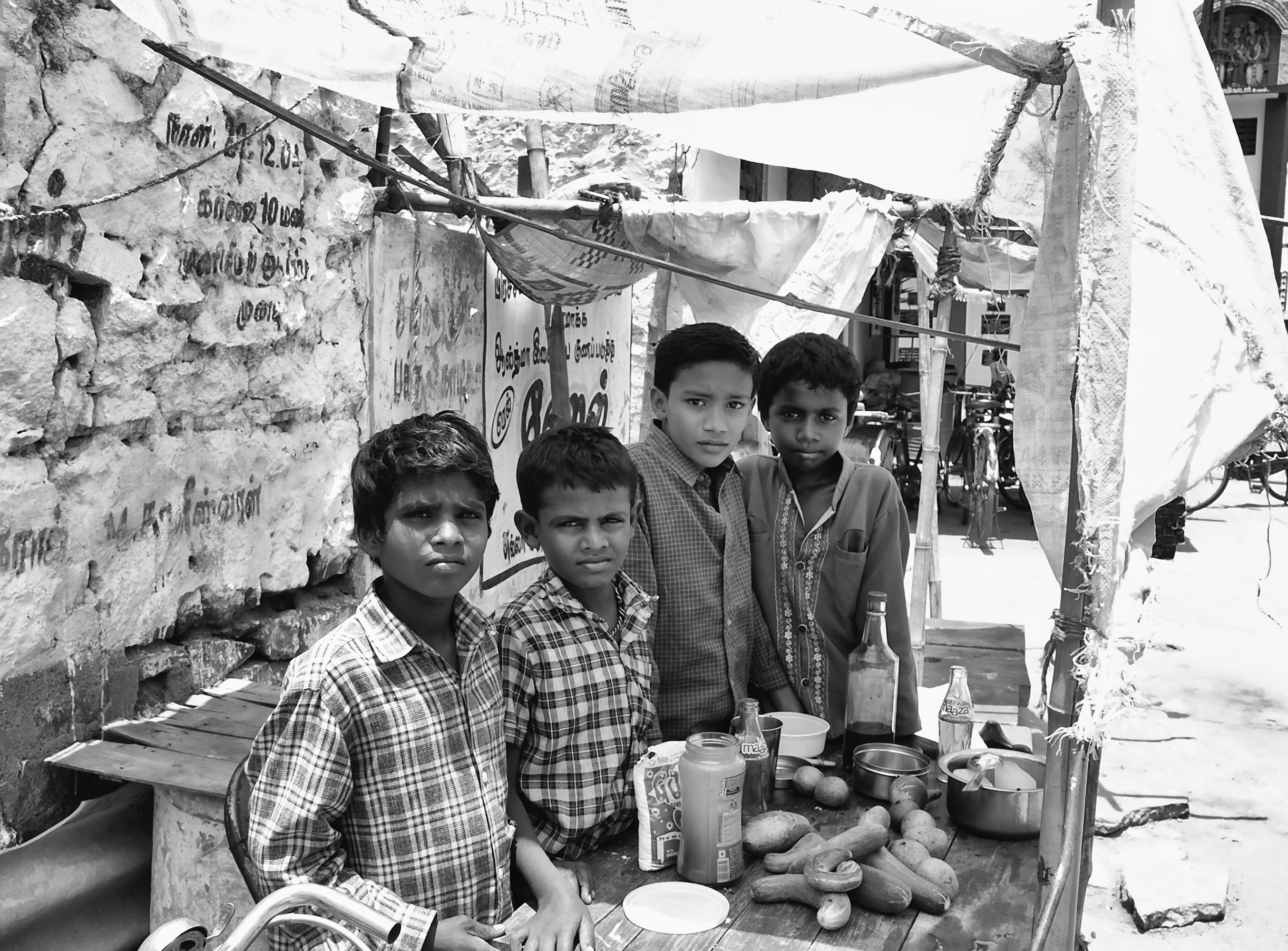 Kids setup a petty shop to sell cucumber and cool drinks in their summer holidays; the money they hoped to pay for their school fees. Virudhunagar, India.