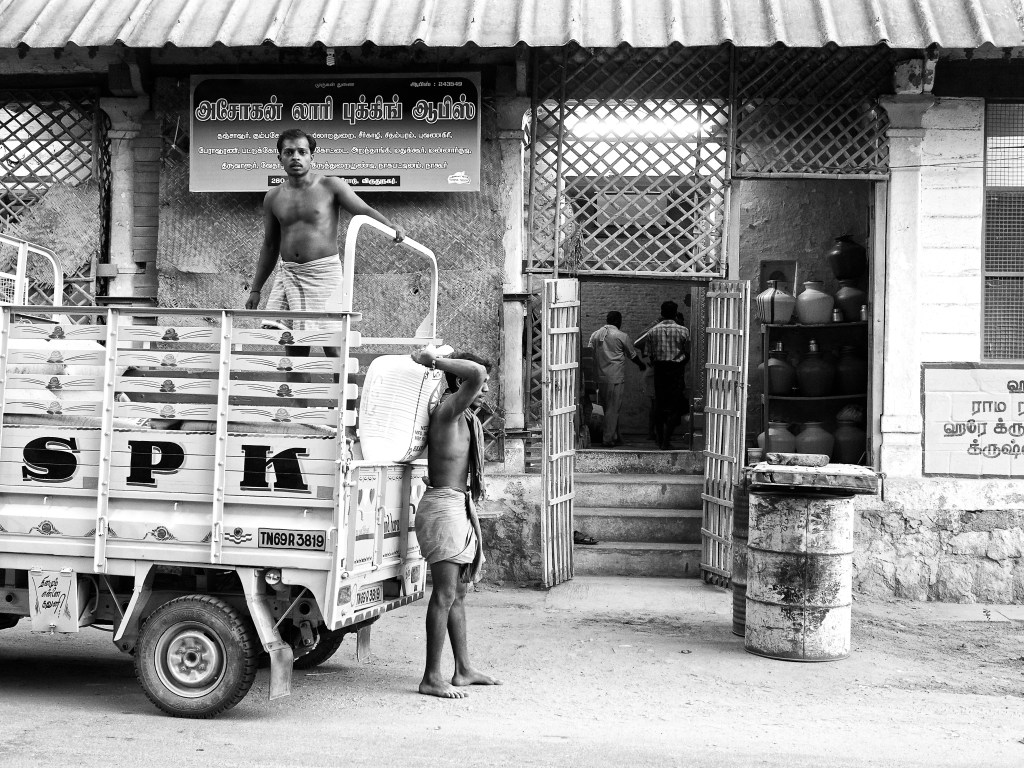 Loading men transporting the goods from a mini lorry, Virudhunagar, India