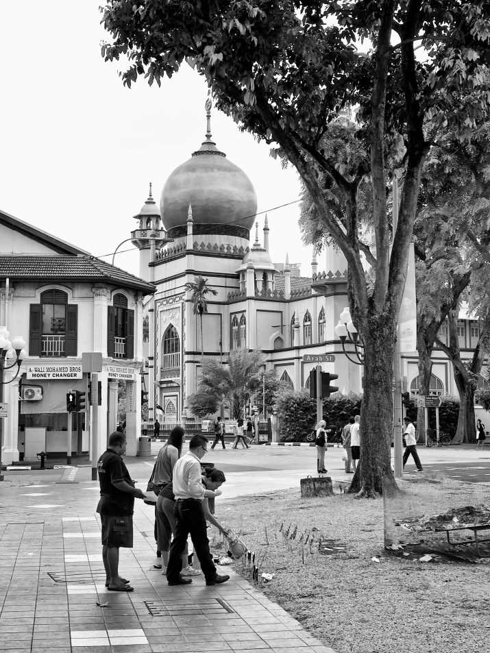 People burning joss paper and praying for ancestors by the road side, Bugis, Singapore