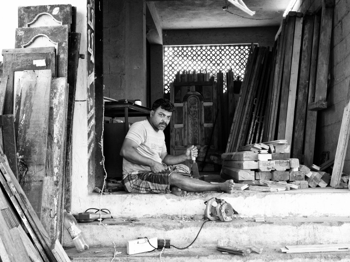 A carpenter at work in his street-side workshop, Madurai, Tamil Nadu, India