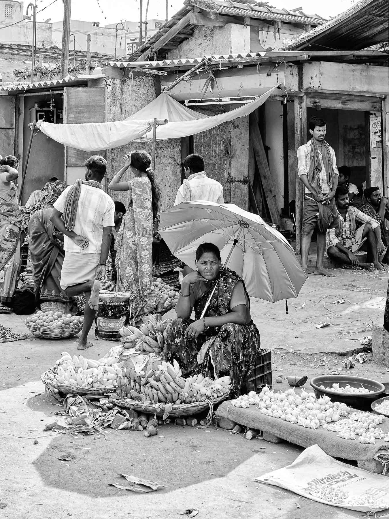 A woman street vendor selling bananas in the market place, Madurai, Tamil Nadu, India