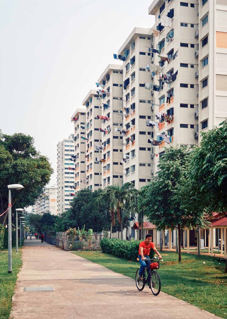 A cyclist outside a public housing estate, Paya Lebar, Singapore